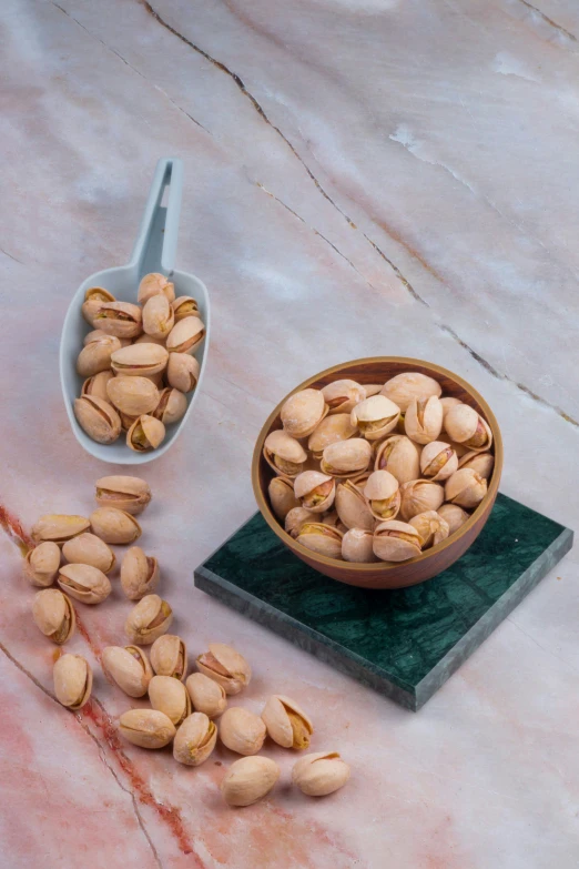 a large wooden bowl with nuts next to it