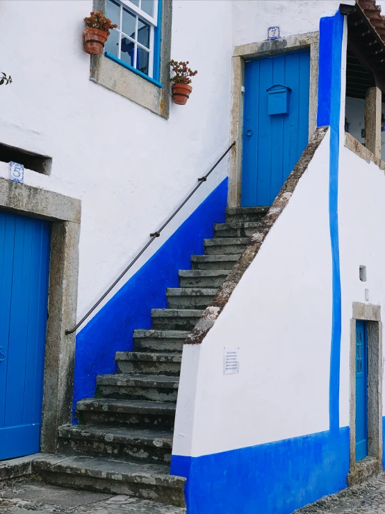 a po of some steps and a door in the middle of a building