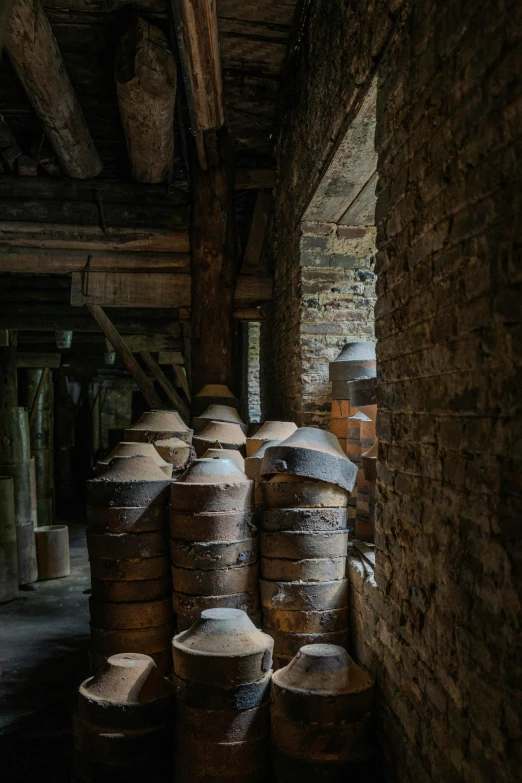 a row of clay pots in the back of a building