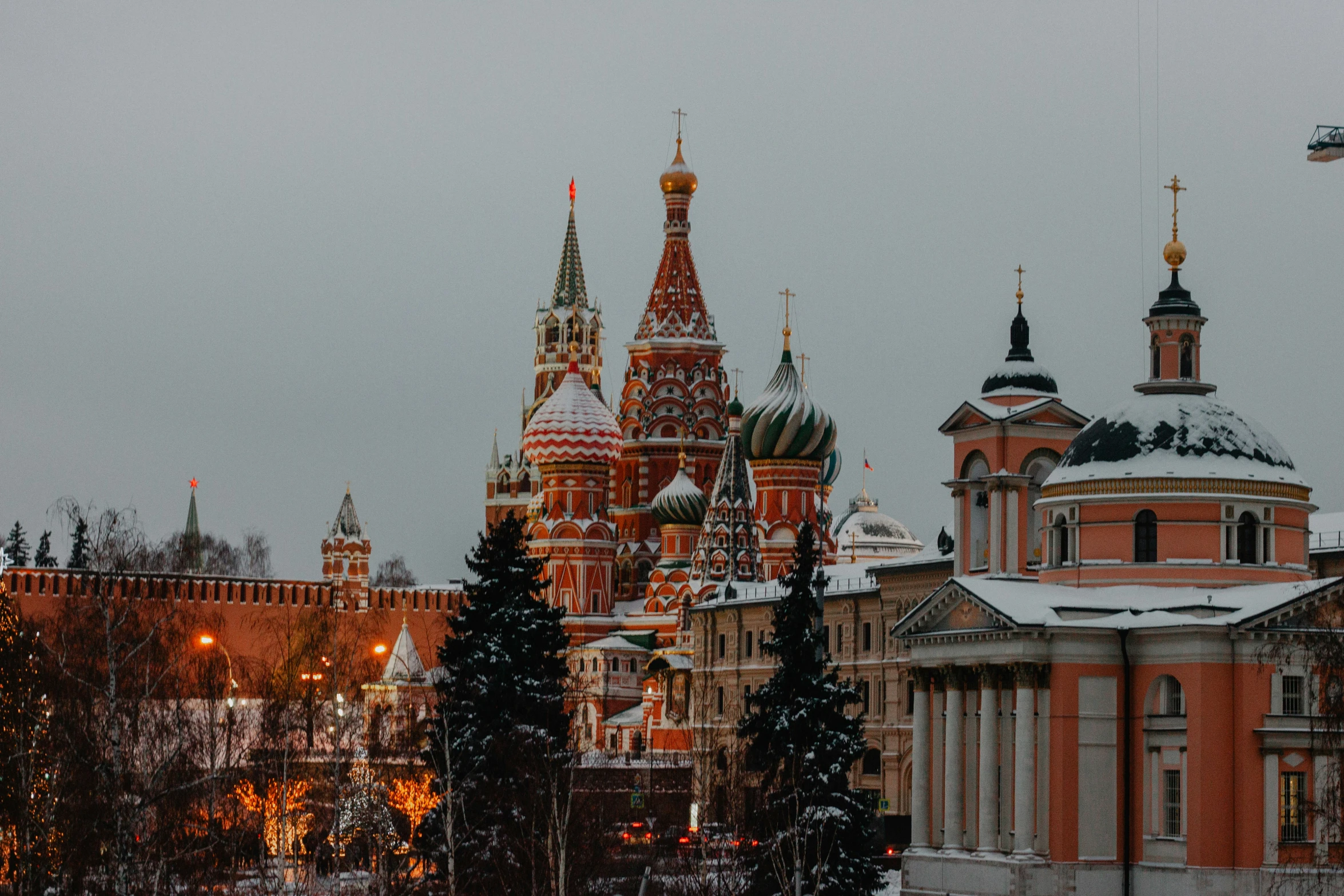 the towers of a large building are covered in snow