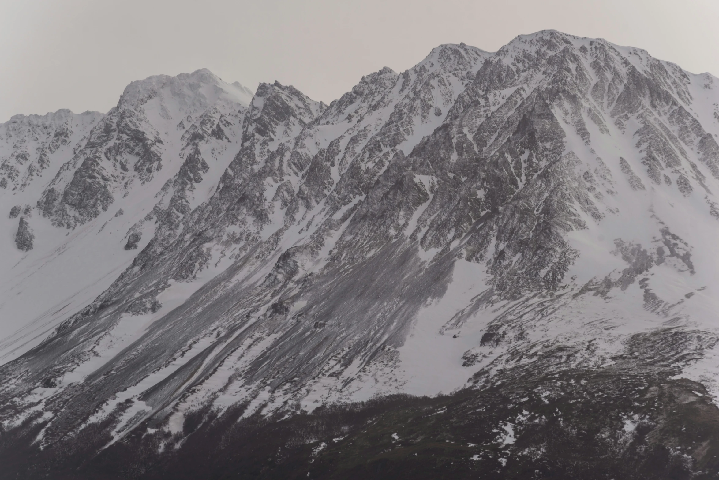 a mountain covered in snow and lots of tall mountains