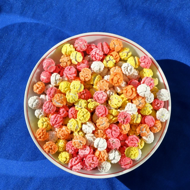 a white bowl filled with tiny colorful treats