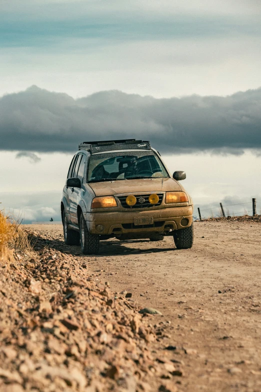 a car driving down a road in the desert