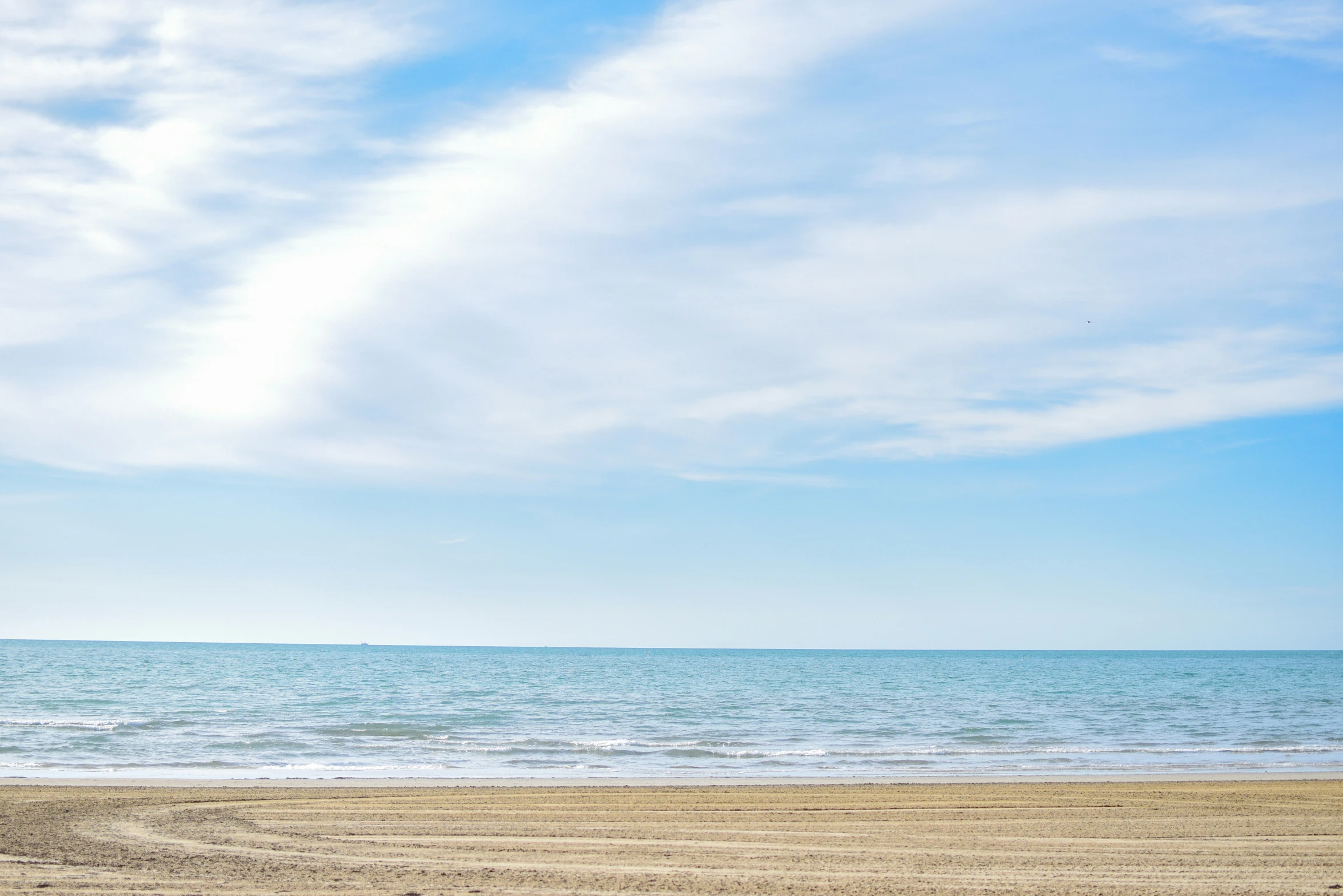 there are two people that are walking on the beach with their surfboards