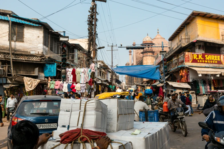 a market place with people and cars in it