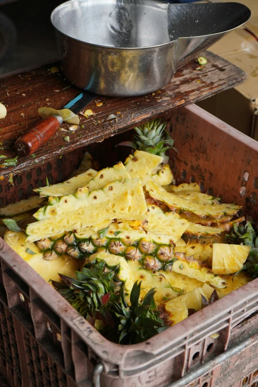 a metal pan in a bin with yellow food