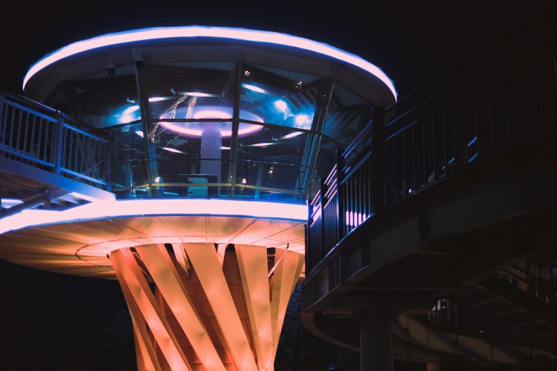 a clock tower at night with light reflecting on it