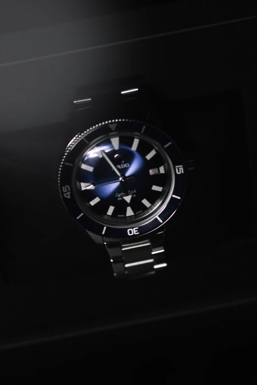 a watch is shown in the dark and black