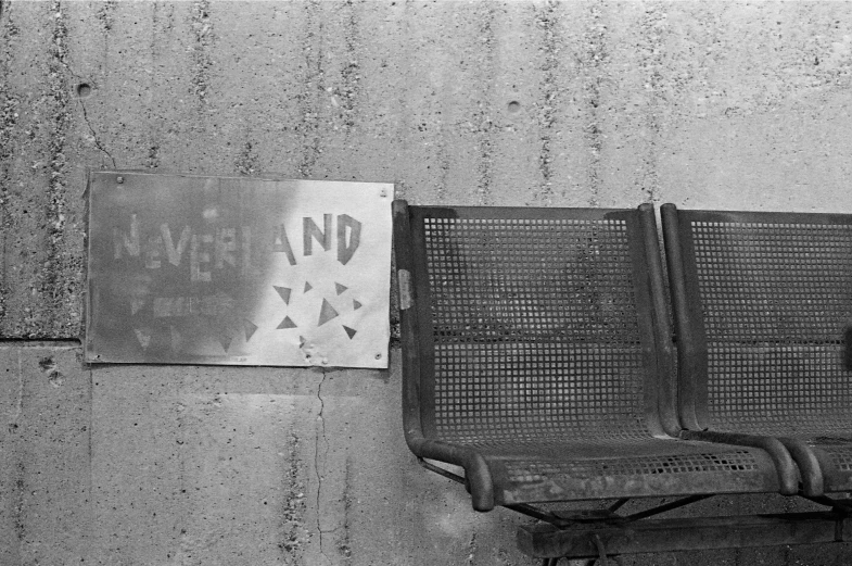 a street sign and some metal objects against a wall