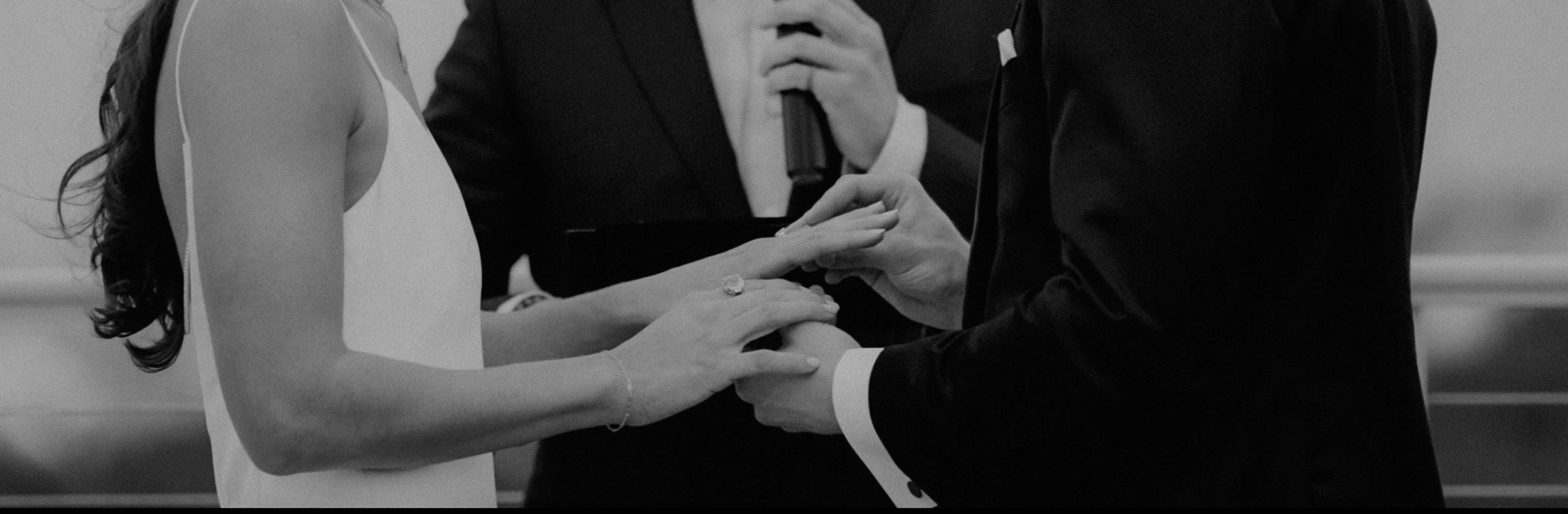 black and white po of bride placing on her tie