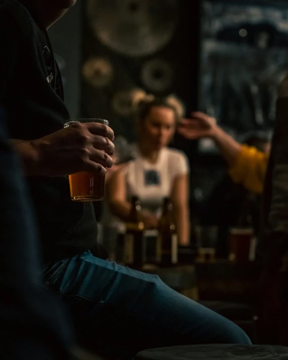 people sitting around with drinks being poured by each other