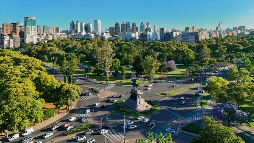 a city is depicted with tall buildings and cars parked on the road