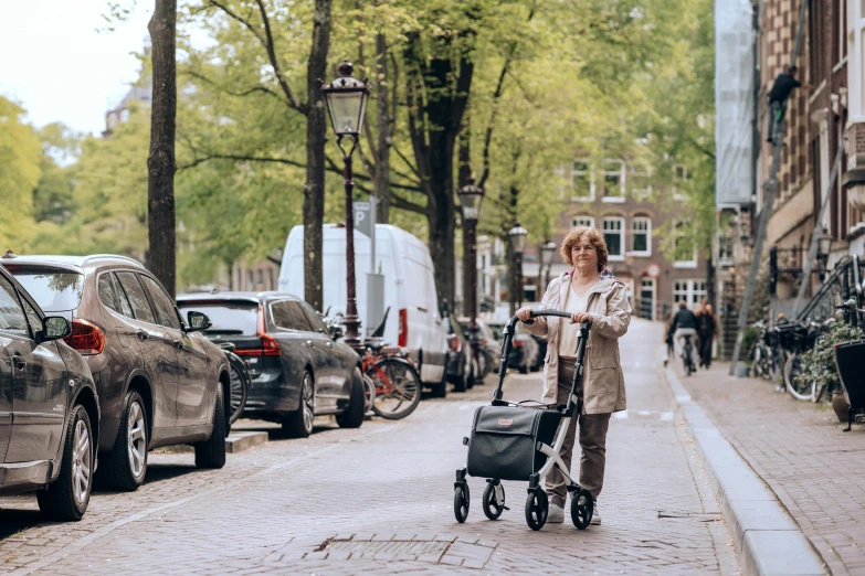 a woman is walking and hing her stroller down the road