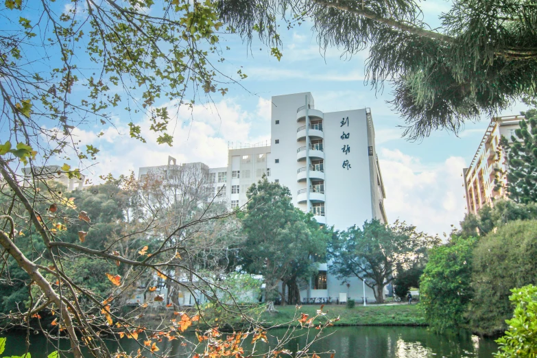 an apartment building on the river is on a bright day