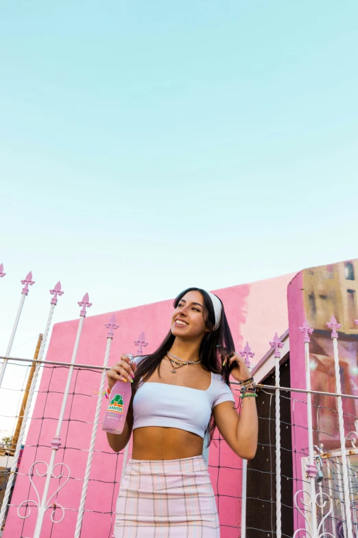 a person that is standing up by a fence