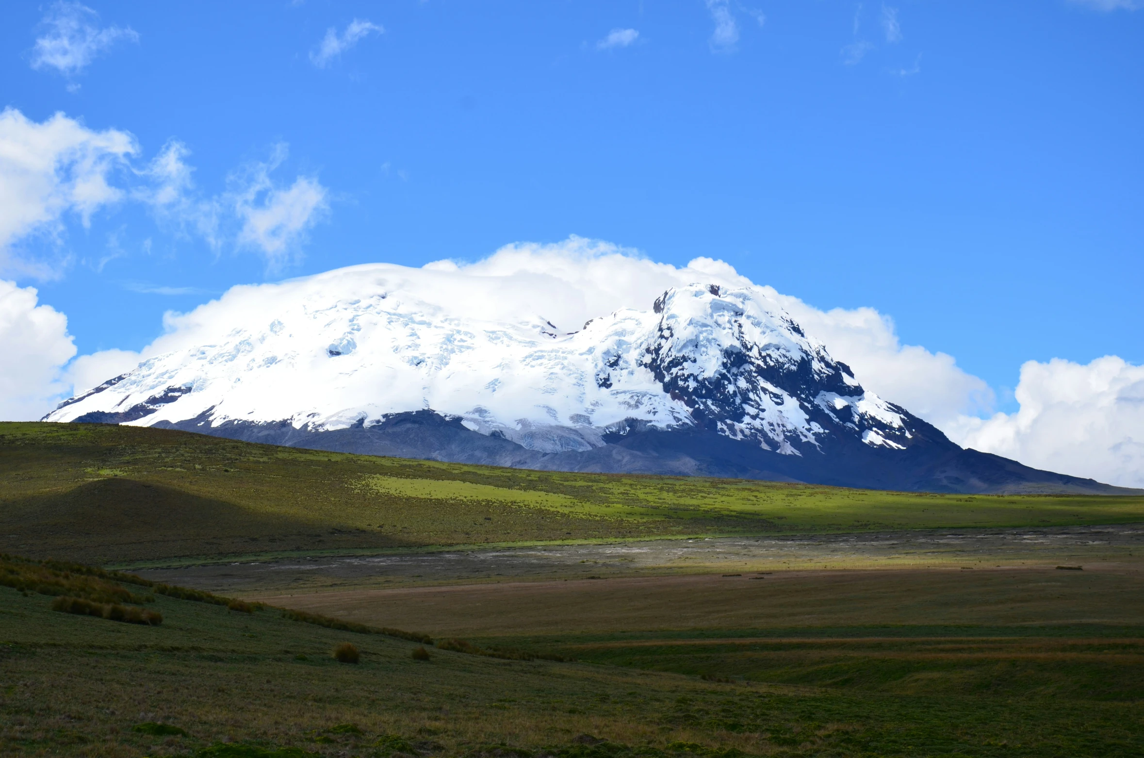 the snow covered mountains are visible on a sunny day