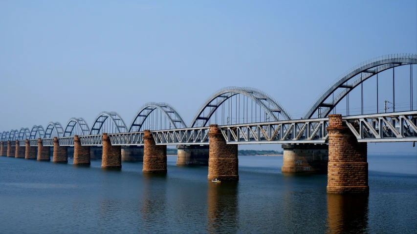 a large bridge crosses over the water in an empty setting