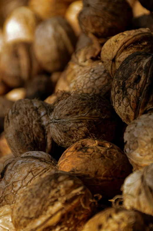 some walnuts that are sitting together in the dark