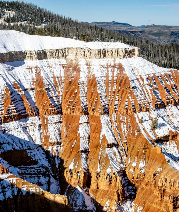 a snow covered hillside with many rocks on it