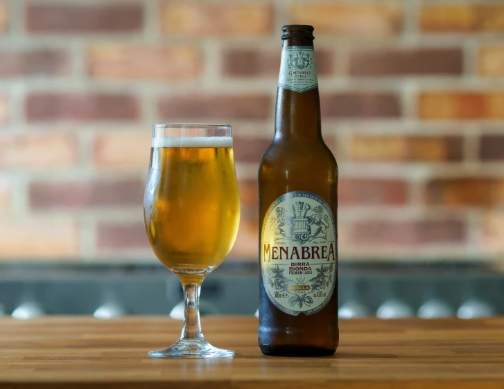 the beer glass has beer next to it on the table