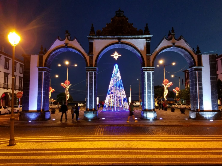 a decorated christmas tree is surrounded by archways