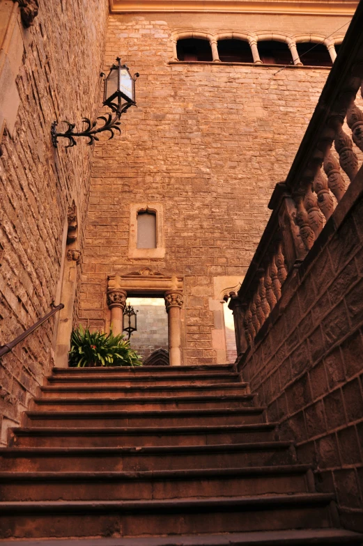 the bottom of stairs that lead up into an old brick building