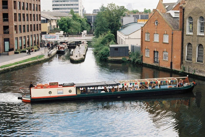 the boat is carrying passengers up a river