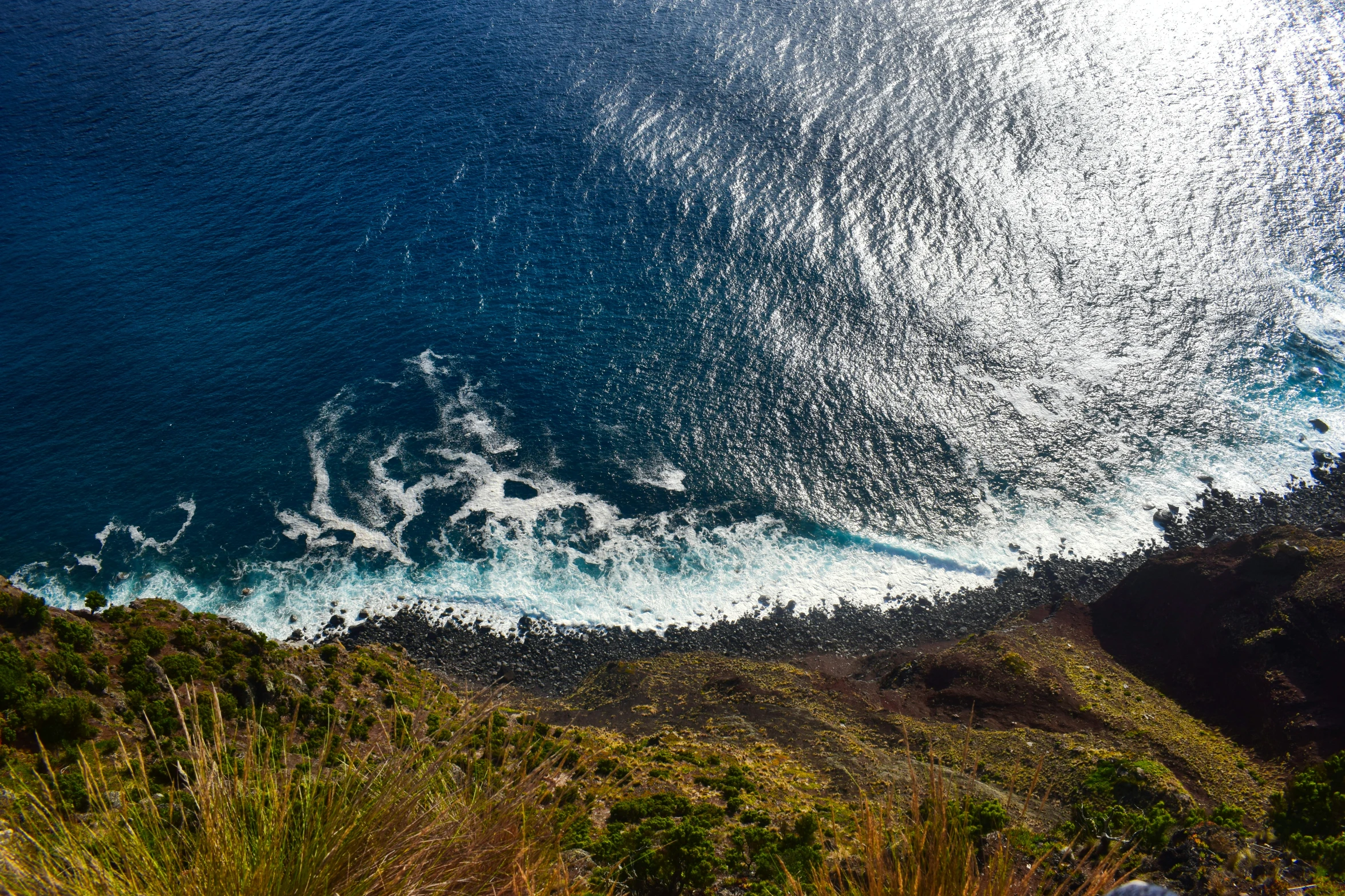 an ocean filled with waves under a clear blue sky