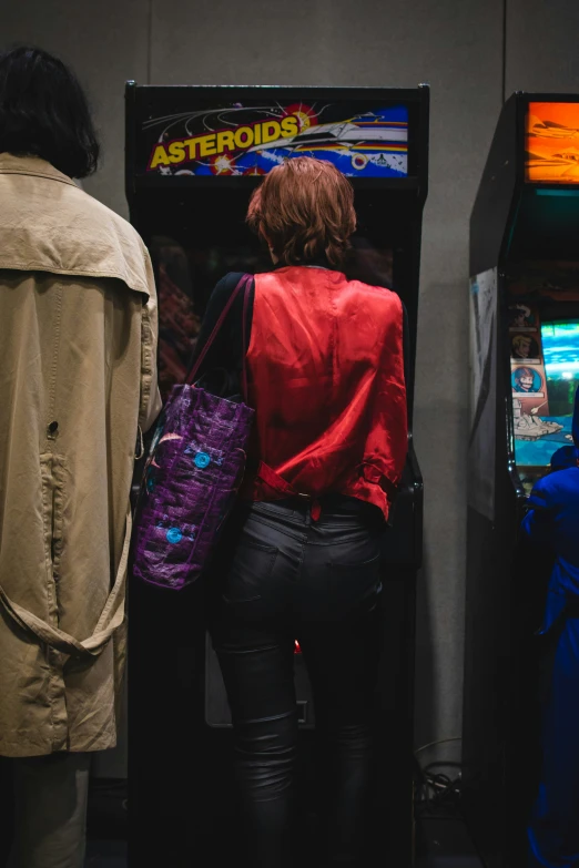 a couple of people standing in front of a machine