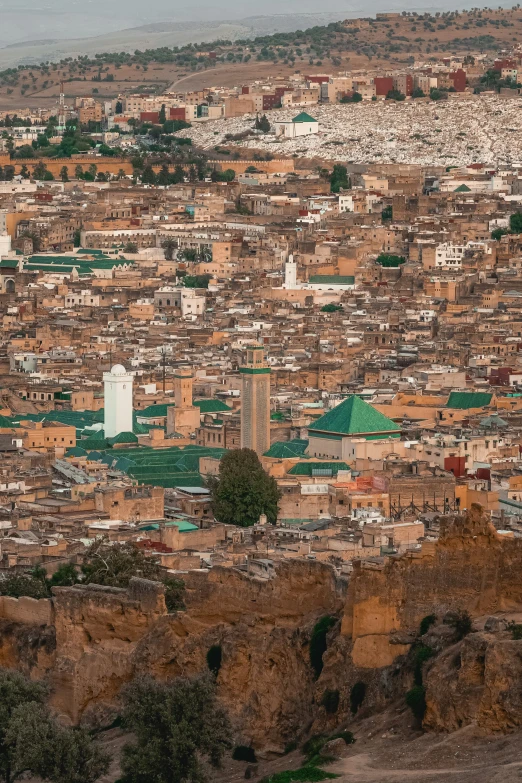 a view from a mountain over a city with tall buildings