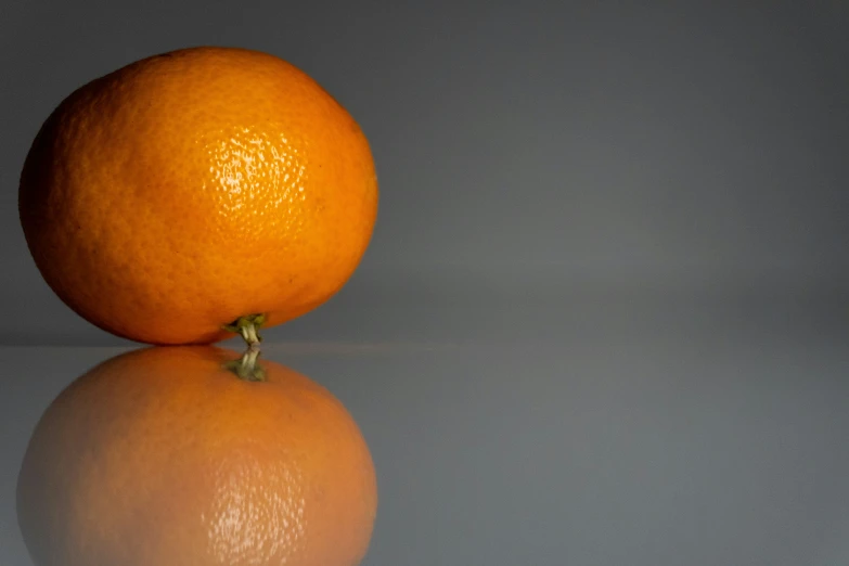 a close up view of an orange with reflection