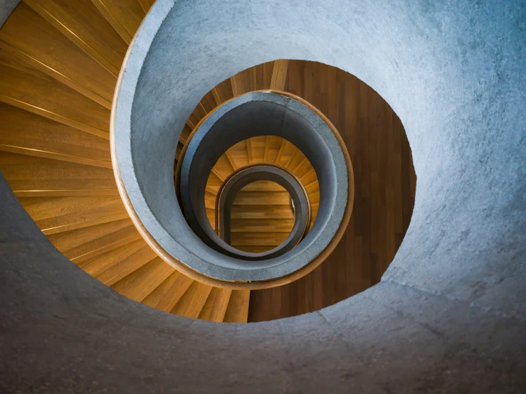 wooden spiral stairs in the middle of a building