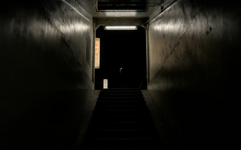 a dark hallway with only the light on