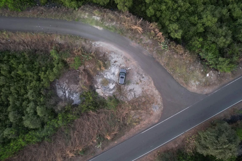 an aerial view shows a van on the side of a road