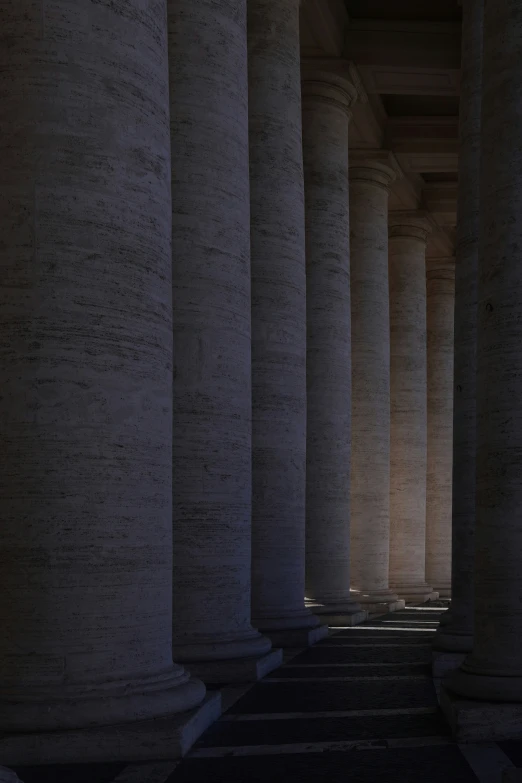 the pillars in the building with several lights inside