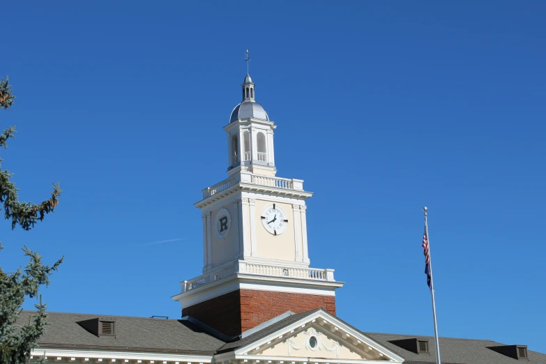 a building with a white clock tower on top