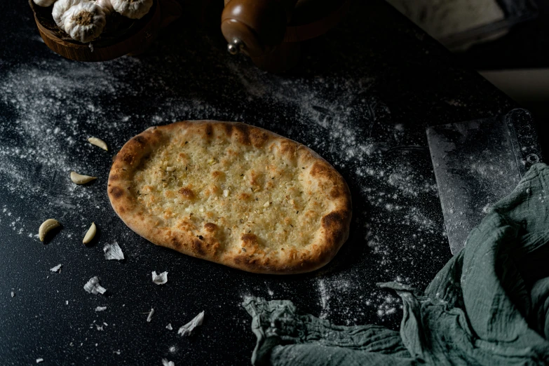 a pizza and other toppings sit on a table