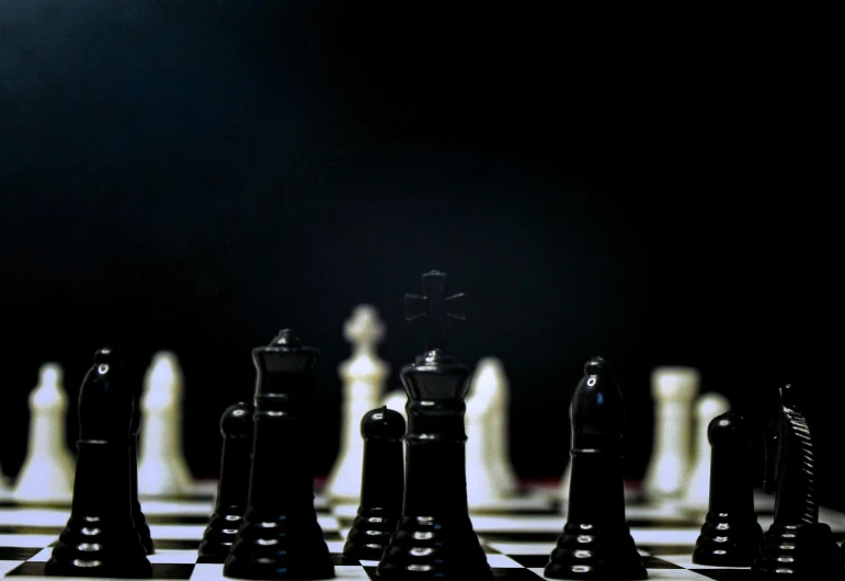 chess boards with black and white pieces on a black background