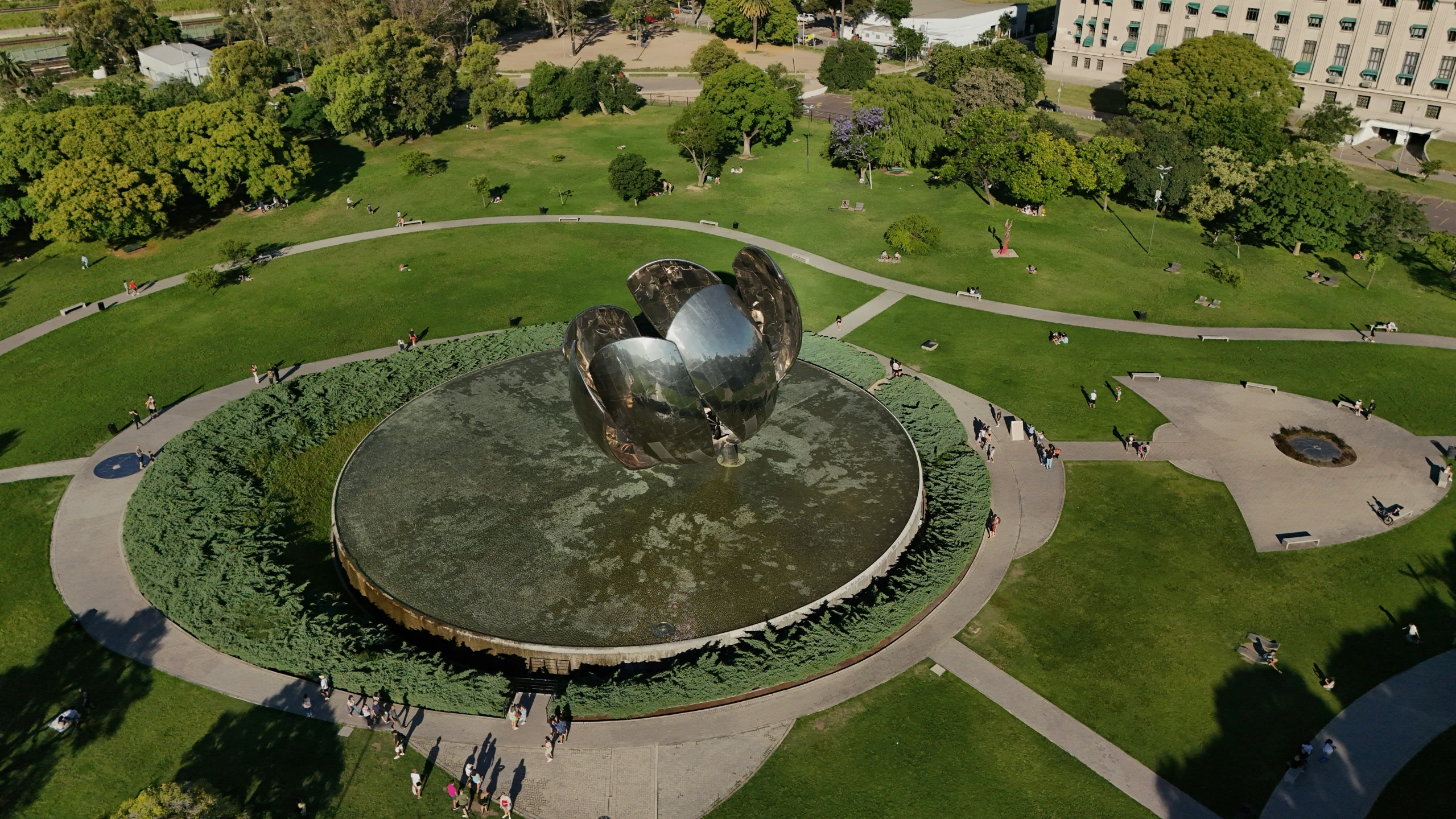 an aerial view of a circle of grass and metal structures