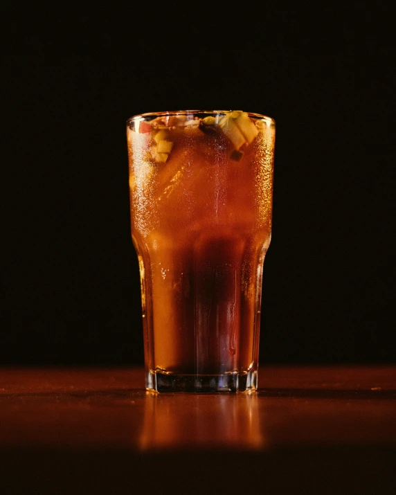 a cold drink being poured in to a glass on a table