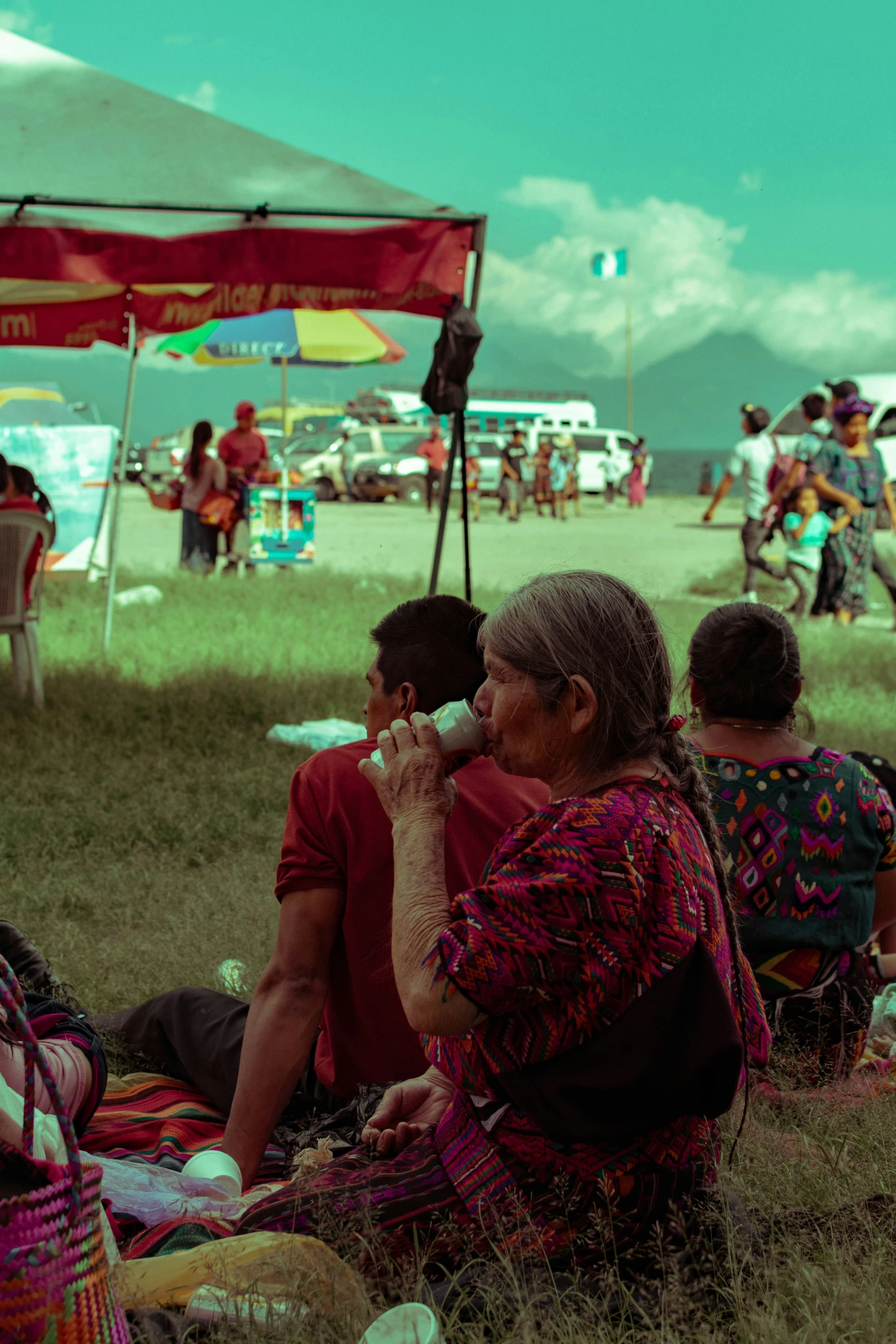 people on a lawn and on the grass in a field