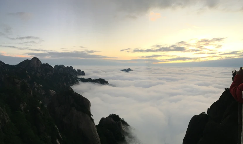 a large mountain with rocks under a blue cloudy sky