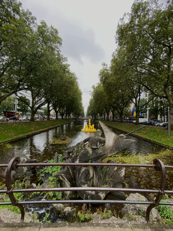 a water way with statues in the water