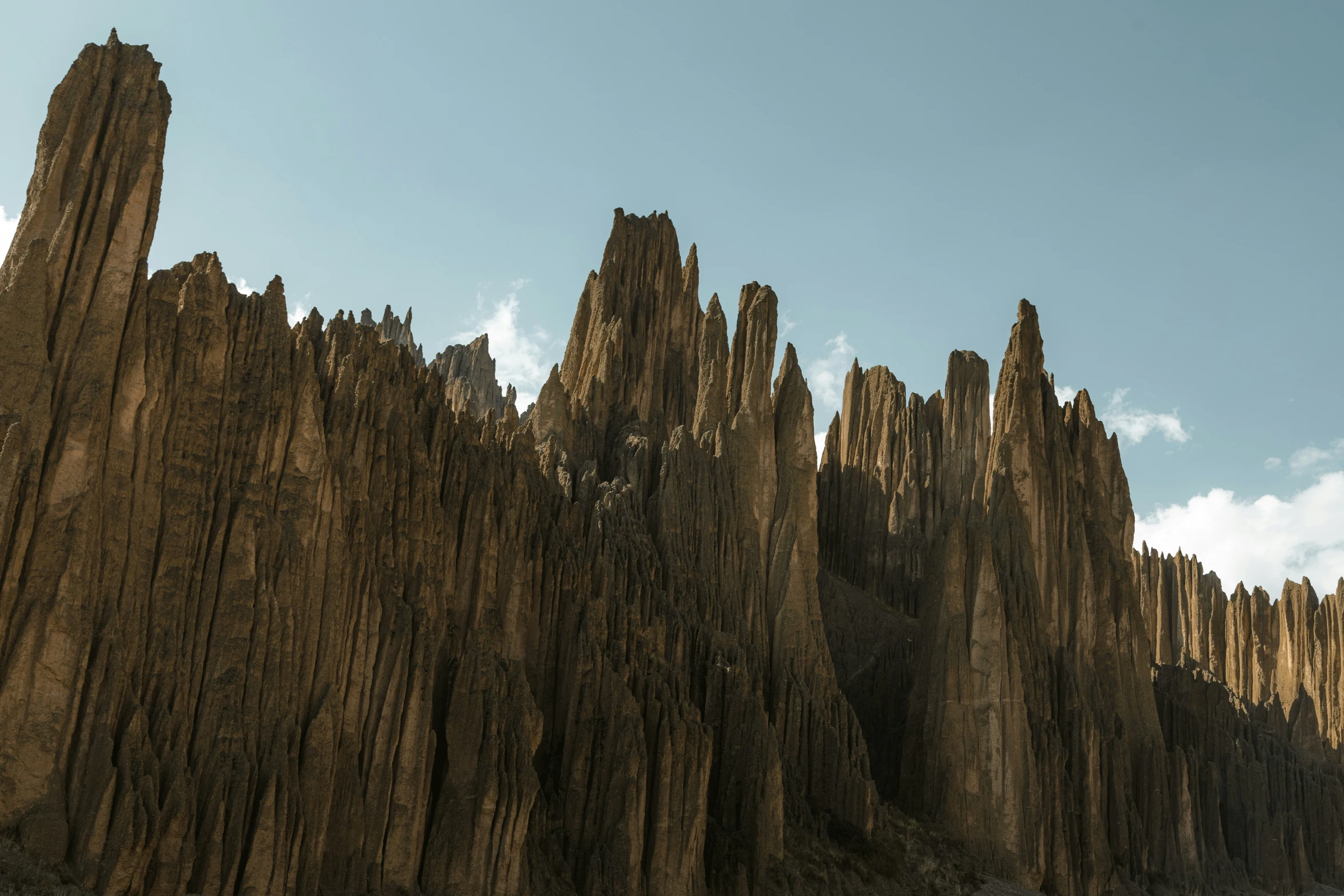 a huge formation of rocks on a beach