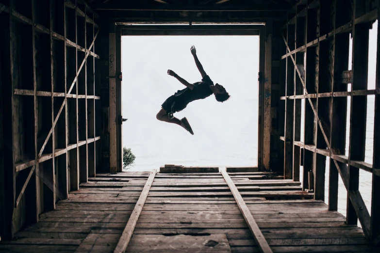 a person standing on a rail holding onto an object