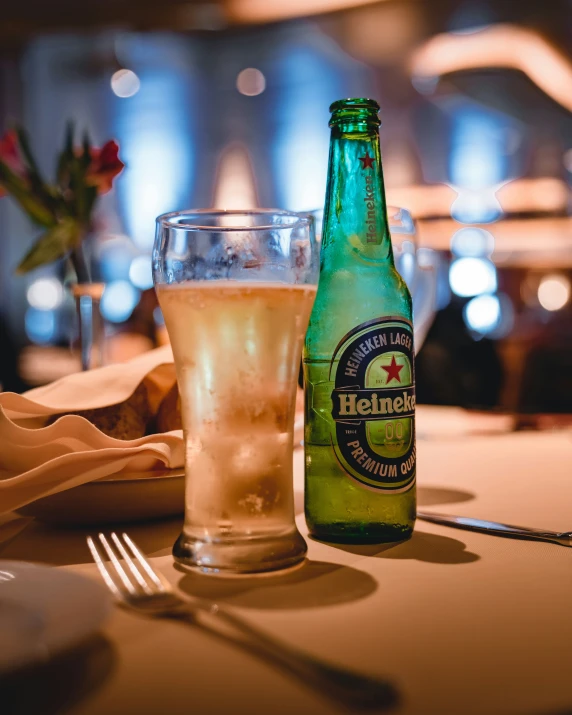 a bottle of beer and glasses sitting on a table