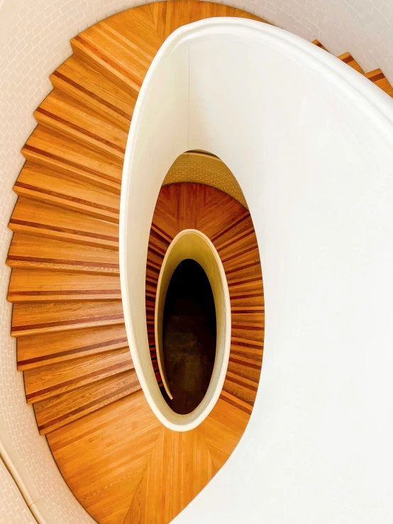 the bottom view of a wooden staircase looking down