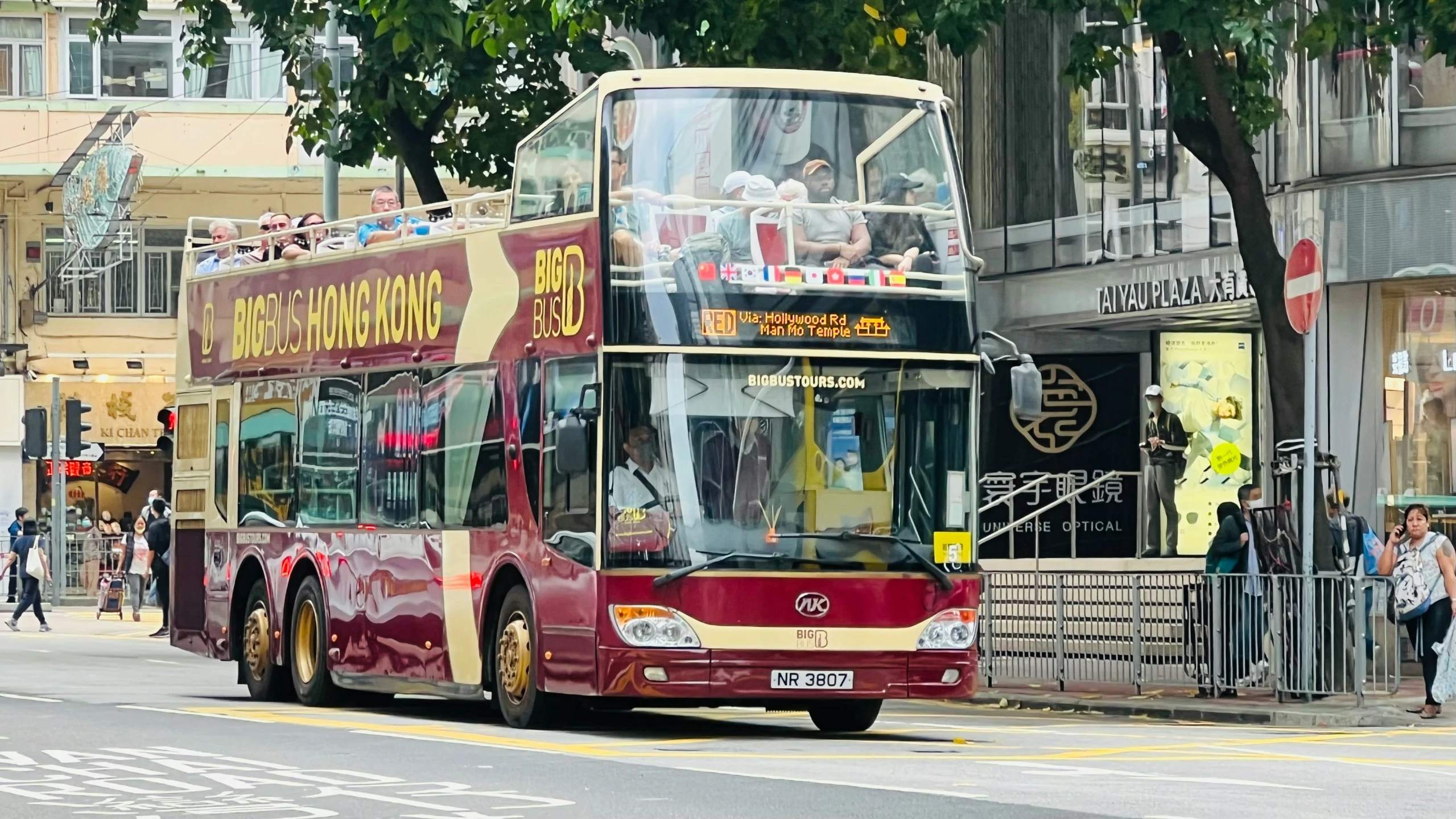 the large double decker bus is driving down the street