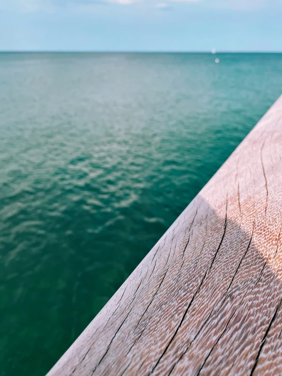 a wooden pier stretching over to the ocean