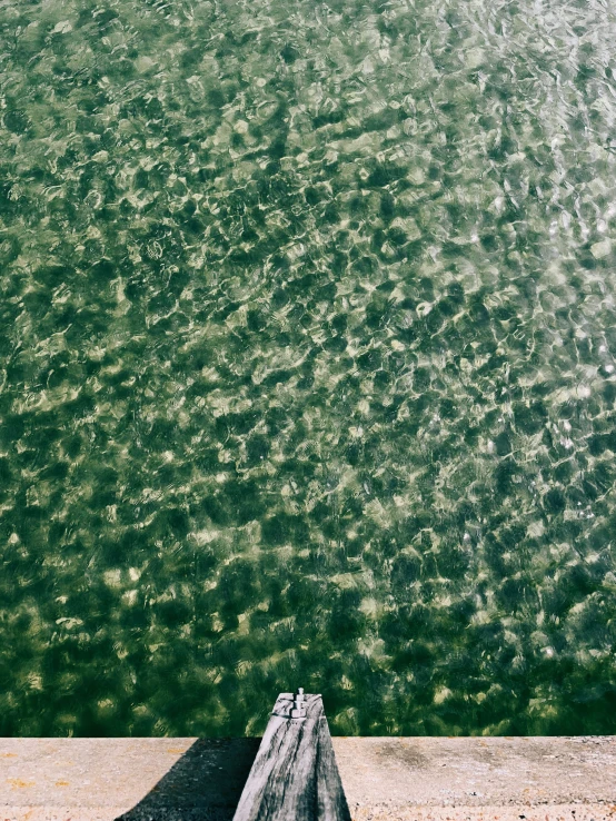 the water and a bench are reflecting light